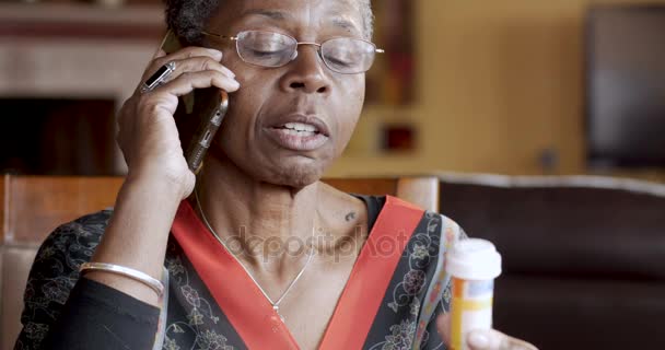 Happy black woman completing her prescription drug order on her cell phone — Stock Video