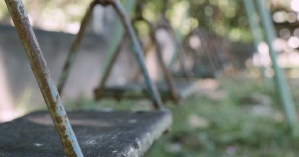 Close up of an old wooden swing deteriorating from age and the weather — Stock Video