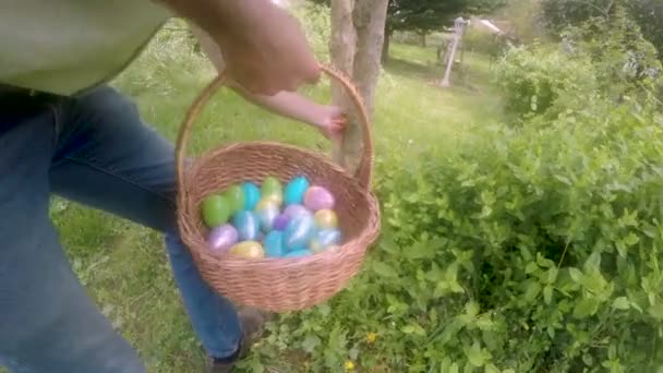 Hombre escondiendo un huevo de Pascua para una tradicional búsqueda de huevos de Pascua — Vídeo de stock