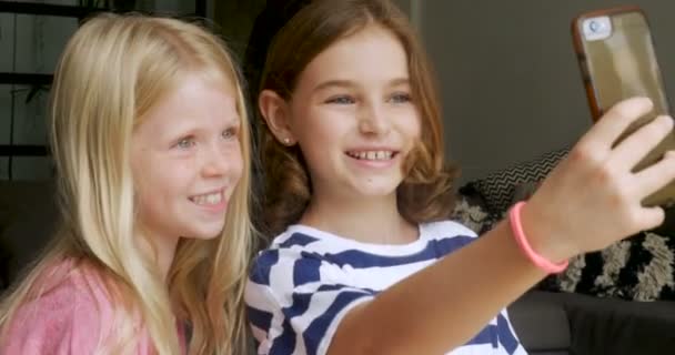 Duas meninas bonitas tirar fotos selfie com um telefone inteligente — Vídeo de Stock