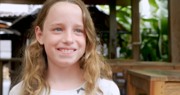 Portrait of a 10 - 11 year old girl smiling and looking at camera — Stock Video