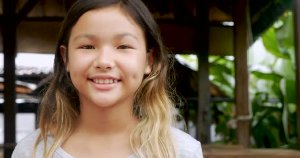 Portrait of young 11 - 12 year old cute happy Asian girl smiling — Stock Video