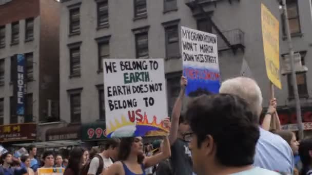 Jóvenes de 20 a 30 años algo que la gente que lleva señales de cambio climático en una protesta en Nueva York — Vídeo de stock