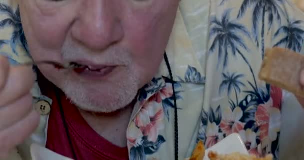 在他的70s 或80s 的一个男人吃一碗通心粉面食关闭 — 图库视频影像
