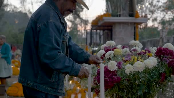 Dolly shot van een oude Mexicaanse mens verlichting een kaars op dag van de doden — Stockvideo