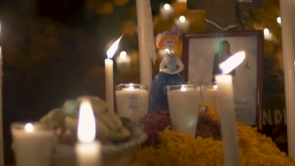 Katrina figurine, photo and candles at a grave during day of the dead — Stock Video