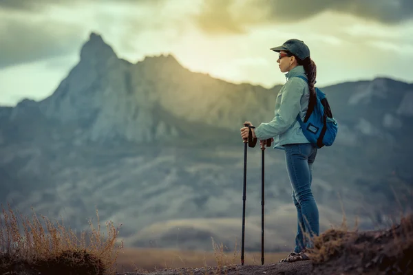 Young traveler with backpack standing on the big stones — Stock Photo, Image