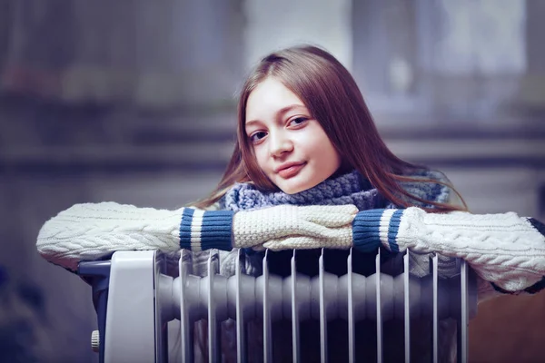 Long-haired woman near electric heater at home — Stock Photo, Image