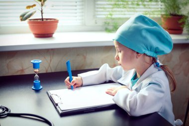 Cute little girl doctor on her rounds clipart