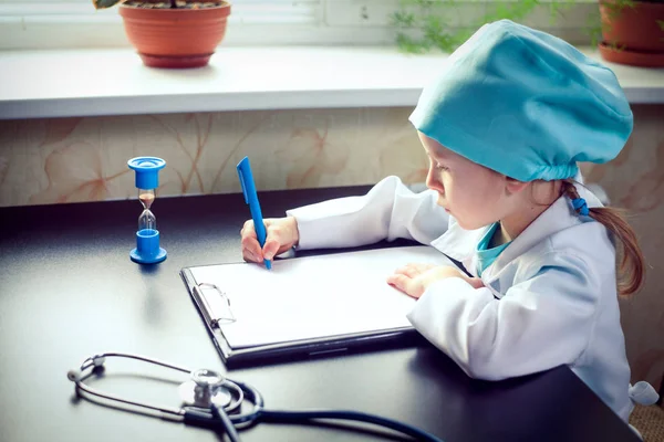 Cute little girl doctor on her rounds — Stock Photo, Image