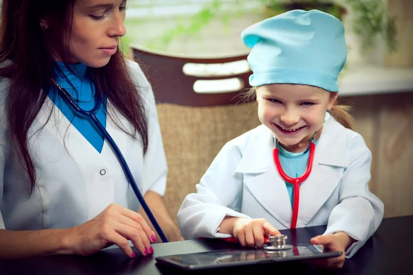 PC doctor examining a laptop computer against white background — Stock Photo, Image