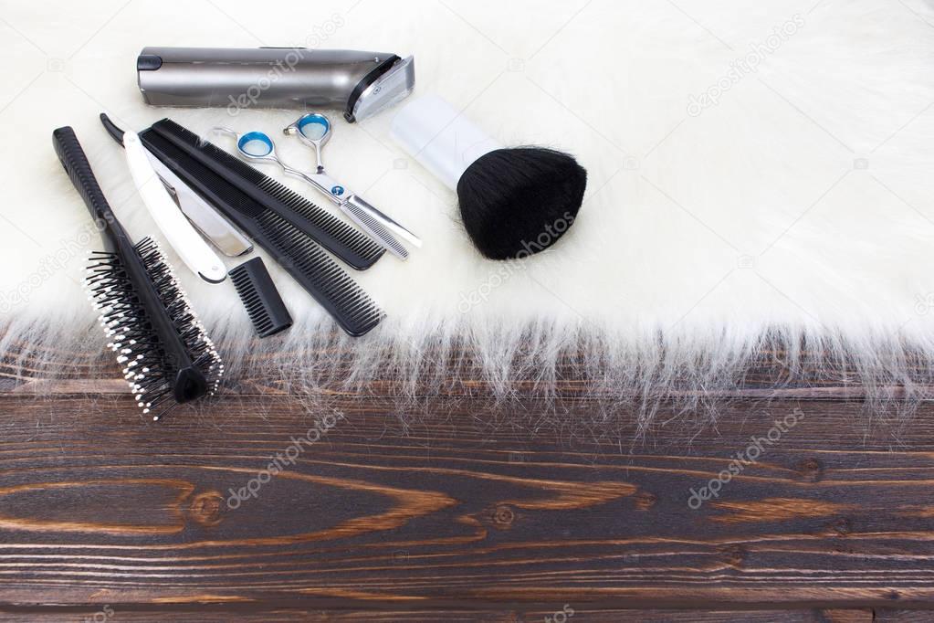 Hairdressing tools on wooden background with copy space