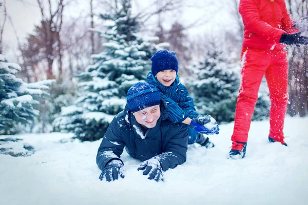 Família atraente se divertindo em um parque de inverno — Fotografia de Stock