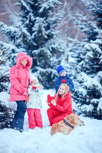 happy family with dog in winter park