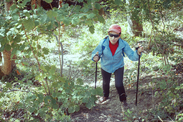Outdoor shot of attractive young woman with backpack standing in