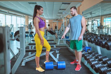 kadının bir eğitmen gözetiminde itme egzersiz yapması