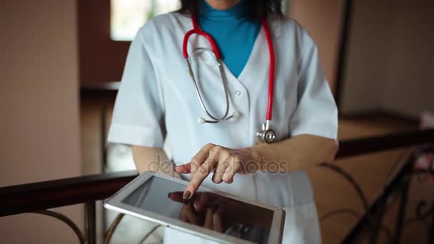 Doctor working on a digital tablet with copy space — Stock Video