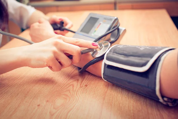 Young female doctor or nurse taking  patients — Stock Photo, Image