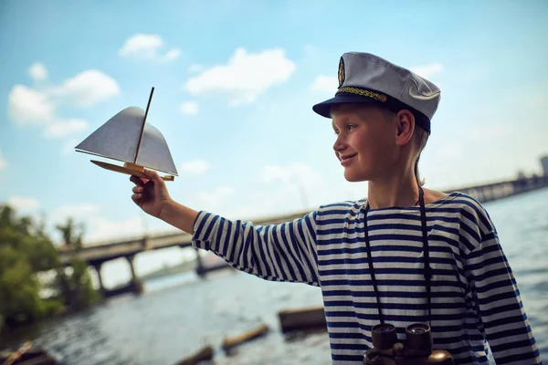 A boy in sailor's striped vest with binoculars — Stock Photo, Image