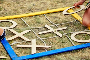 Noughts and crosses on the grass /