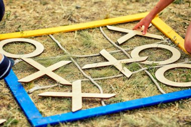 Noughts and crosses on the grass /