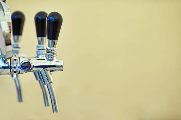 Barman hand at beer tap pouring a draught lager beer — Stock Photo, Image