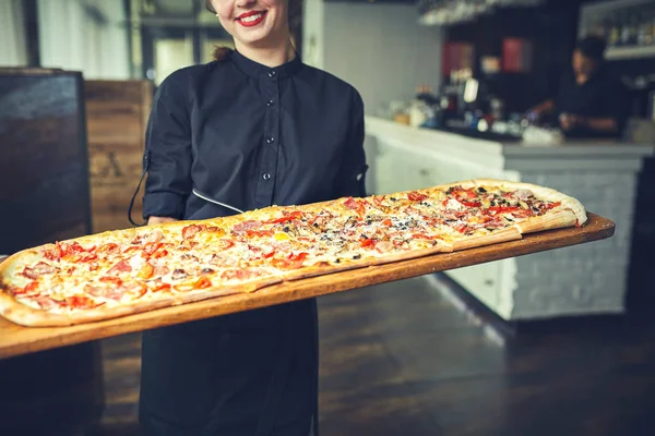 Garçons carregando pratos com comida, em um restaurante . — Fotografia de Stock