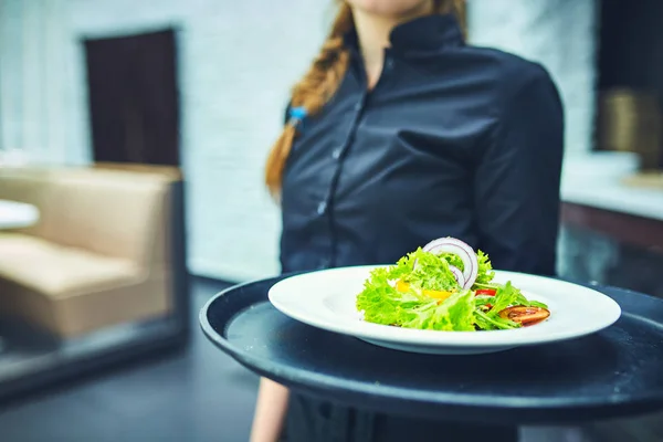 Kelnerzy, niosąc talerze z jedzeniem w restauracji. — Zdjęcie stockowe
