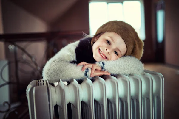 Long-haired woman near electric heater at home — Stock Photo, Image