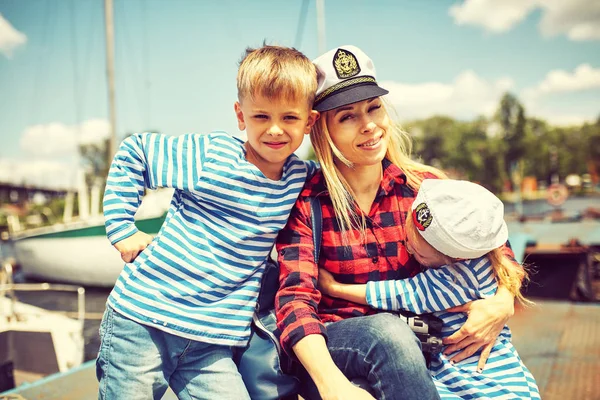 Happy mother with children on the pier — Stock Photo, Image