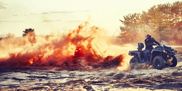 Tiener rijden ATV in zandduinen het maken van een bocht in het zand — Stockfoto