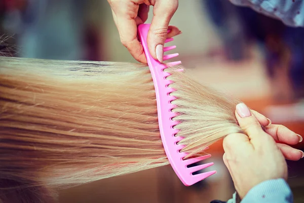 Midsection of male hairdresser drying teenage customer's hair in — Stock Photo, Image