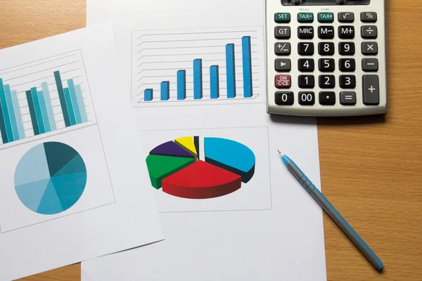 Business chart and graph with pen, calculator