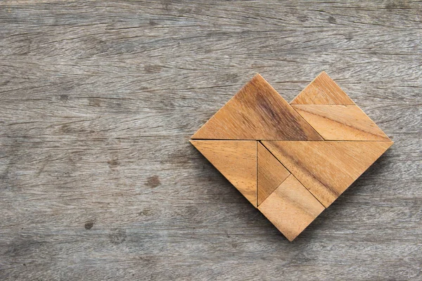 Quebra-cabeça Tangram em forma de coração na mesa de madeira — Fotografia de Stock