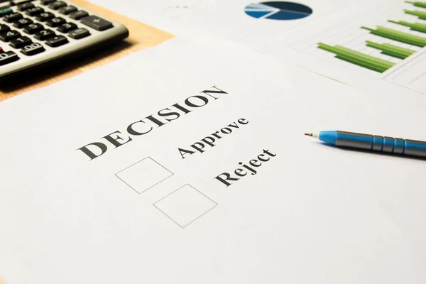 Decision paper for approve and reject with pen, calculator and financial graph