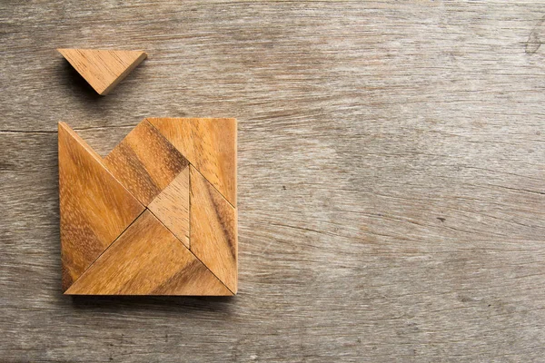 stock image Wooden tangram with one piece is wait to fulfill the square shap