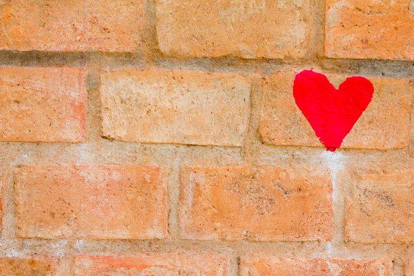 Red heart draw on brown brick wall background