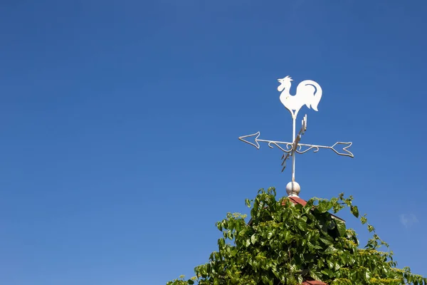 Weiße Wetterfahne zeigt die Windrichtung am blauen Himmel an — Stockfoto