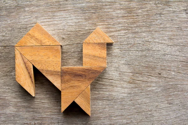 Wooden tangram puzzle in rooster shape background
