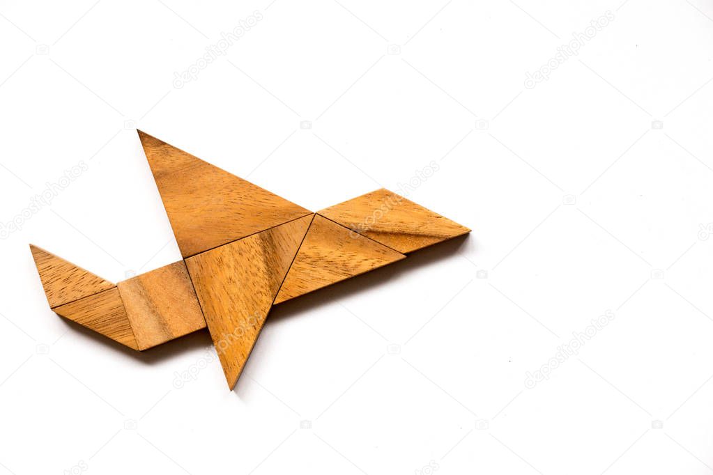 Wooden tangram puzzle in airplane shape on white background (Concept for new experience, start project)