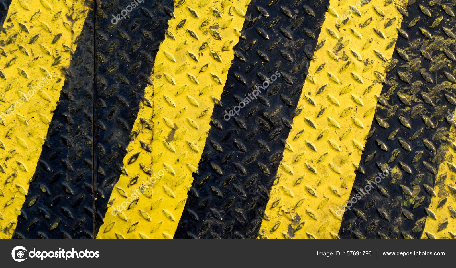 Black and yellow line paint on nonslip metal background Stock Photo by