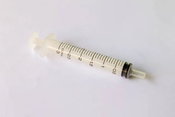 Transparent plastic syringe placed on white background — Stock Photo, Image