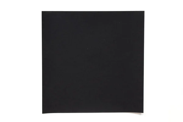 Foglio di carta di colore nero su sfondo bianco utilizzato per la decorazione o elemento di design — Foto Stock