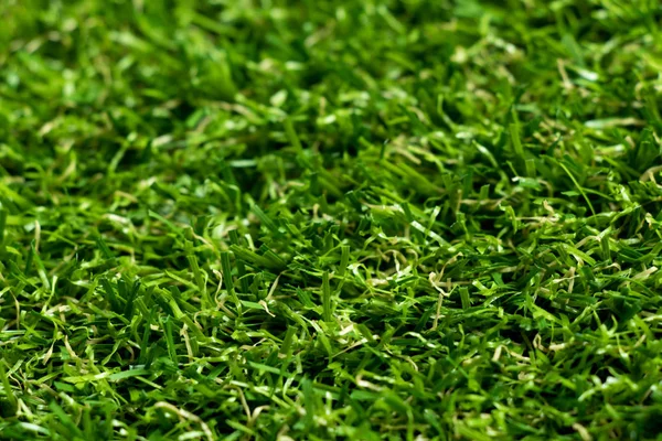 Fechado de fundo de grama verde artificial — Fotografia de Stock