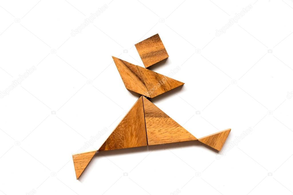 Wooden tangram puzzle in dancing man shape on white background