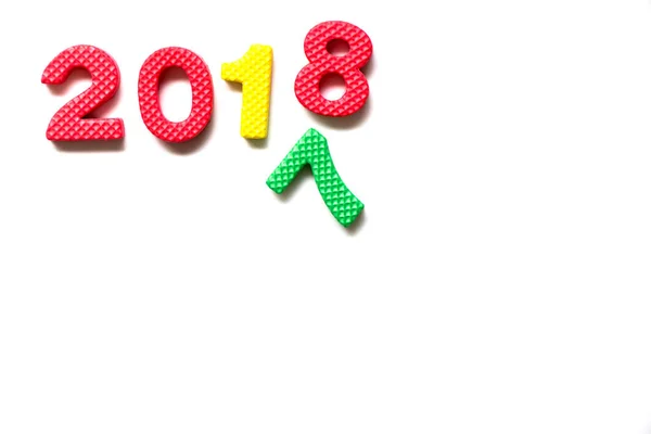 Toy foam alphabet in wording 2018 and falling number 7 on white background (Concept for Happy new year) — Stock Photo, Image