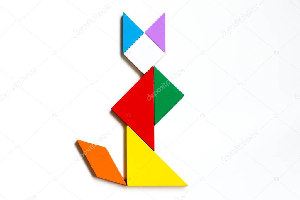 Colorful wood tangram puzzle in sitting cat shape on white background