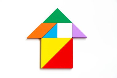Renk ahşap tangram bulmacanın OK veya ev şeklindeki beyaz backgr üzerinde