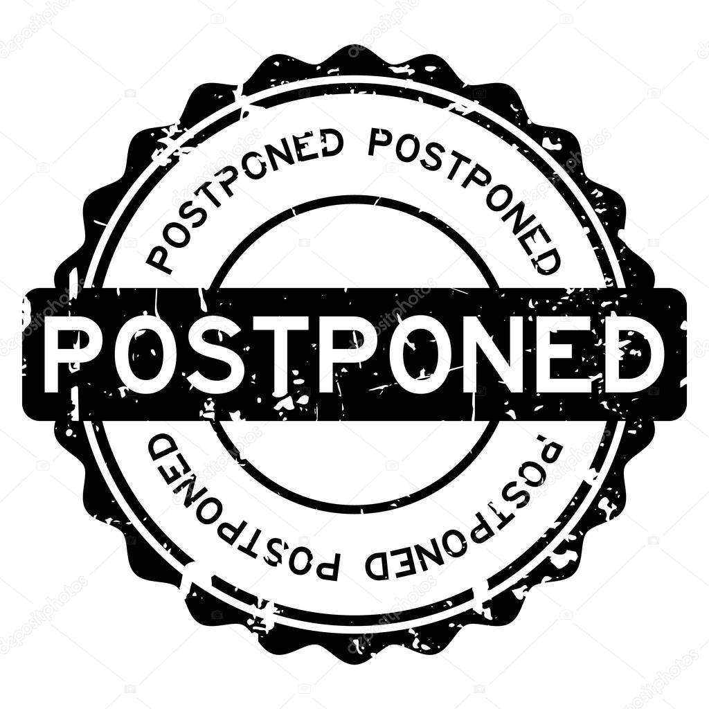 Grunge black postponed word round rubber seal stamp on white background