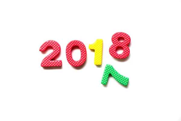 Toy foam alphabet in wording 2018 and falling number 7 on white background (Concept for Happy new year) — Stock Photo, Image